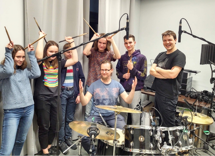 zdjęcie grupy osób w pomieszczeniu z instrumentami muzycznymi